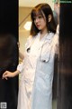 A woman wearing a white lab coat and a stethoscope.
