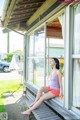 A woman sitting on a bench looking out of a window.