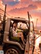 A woman sitting in the driver's seat of a truck.