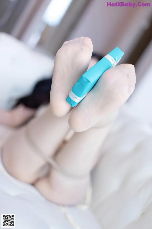 A person holding a blue pen in their hand.